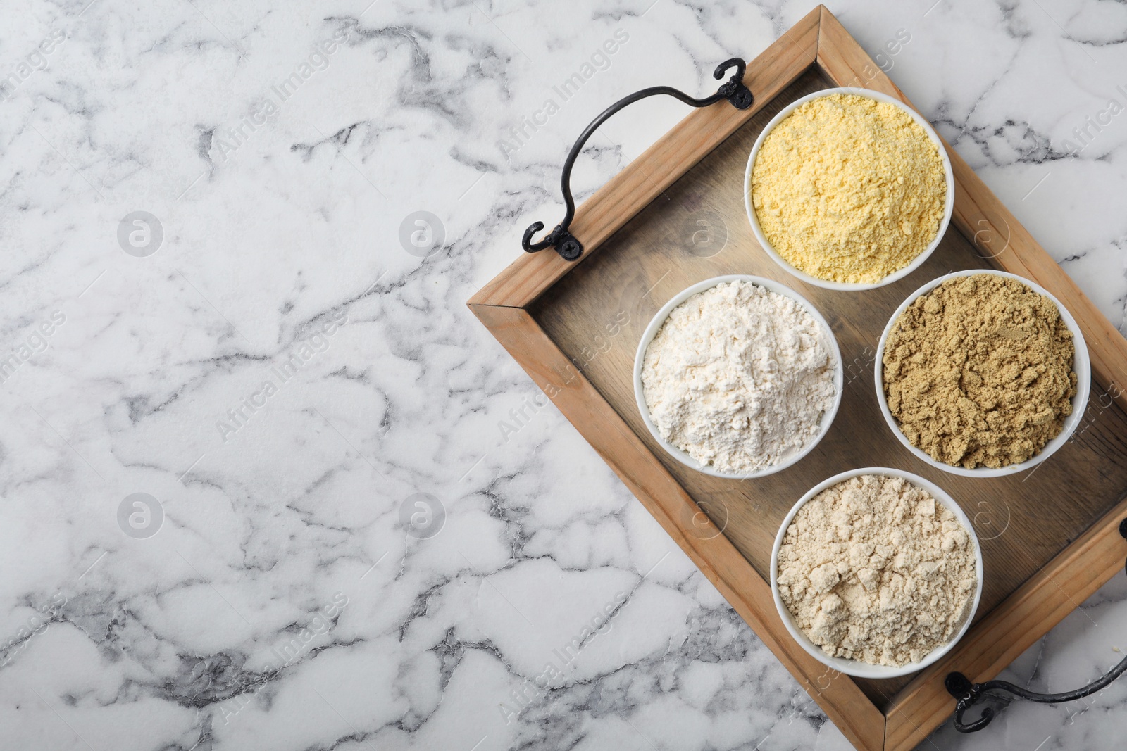 Photo of Composition with different types of flour on marble background