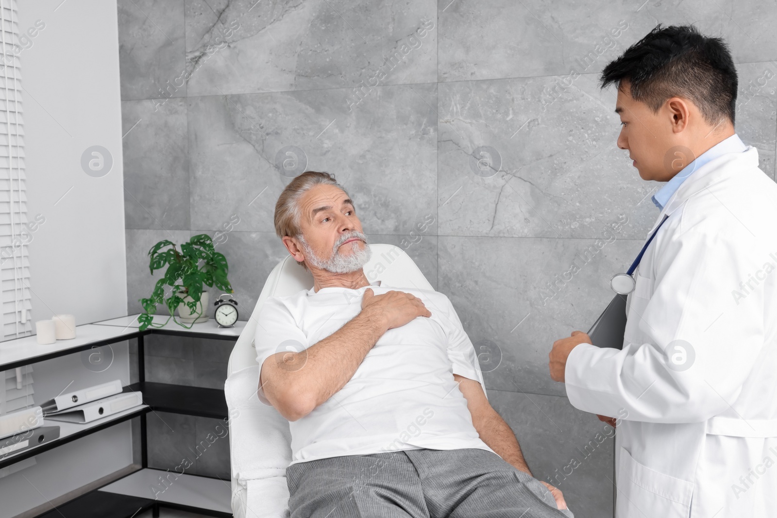 Photo of Senior patient having appointment with doctor in clinic