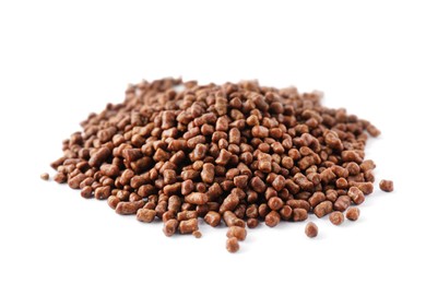 Pile of buckwheat tea granules on white background