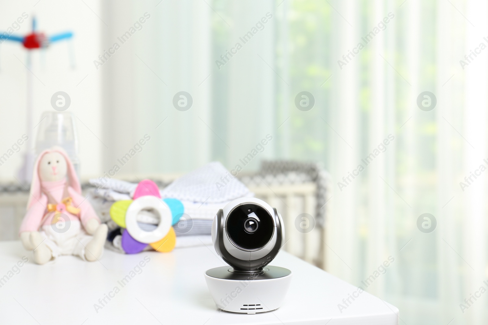 Photo of Baby camera and accessories on table in room. Video nanny