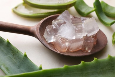 Aloe vera gel and slices of plant on light table, closeup