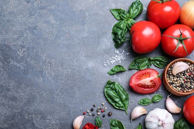 Flat lay composition with fresh green basil leaves on grey table, space for text