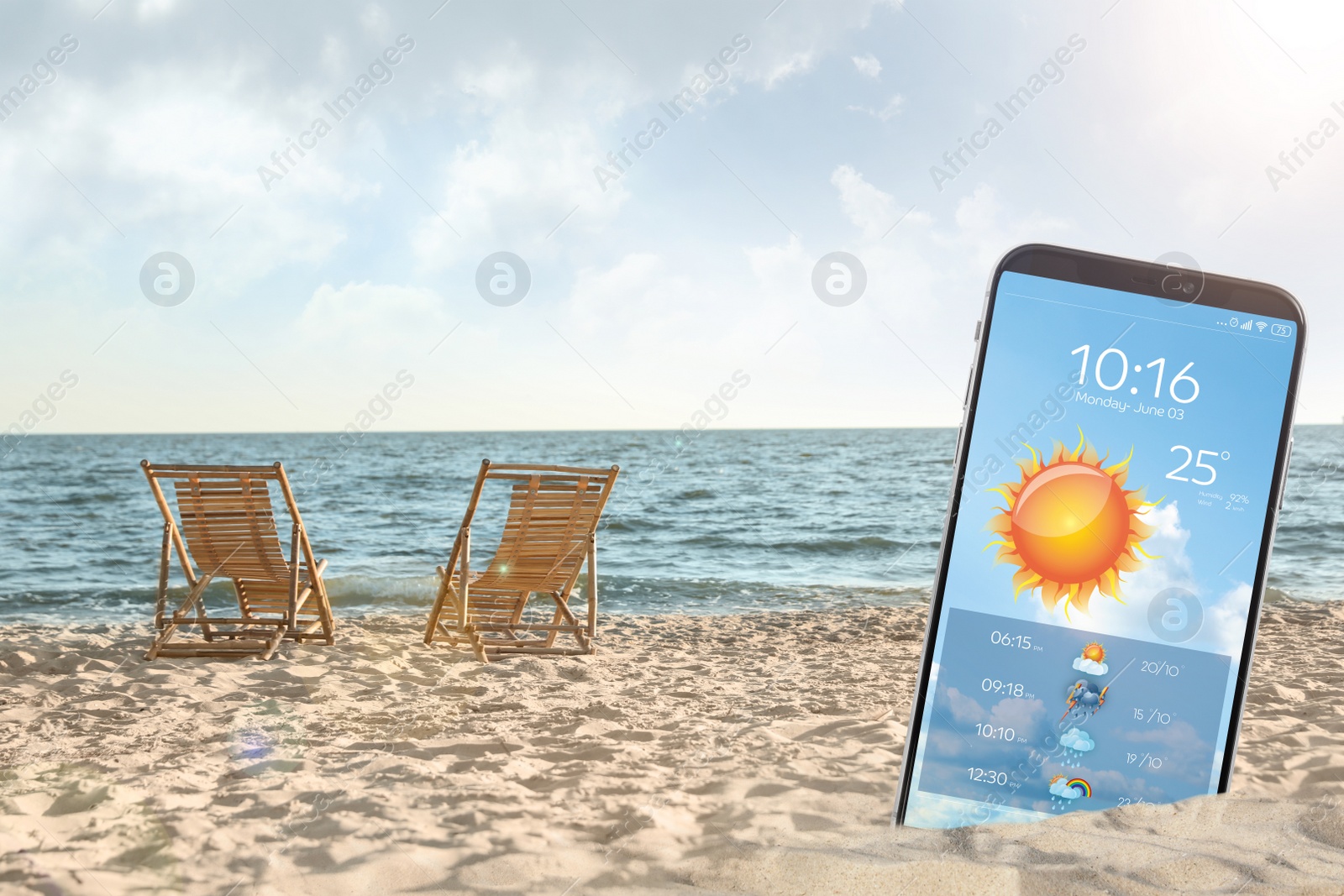 Image of Wooden deck chairs on sandy beach and smartphone with open weather forecast app 