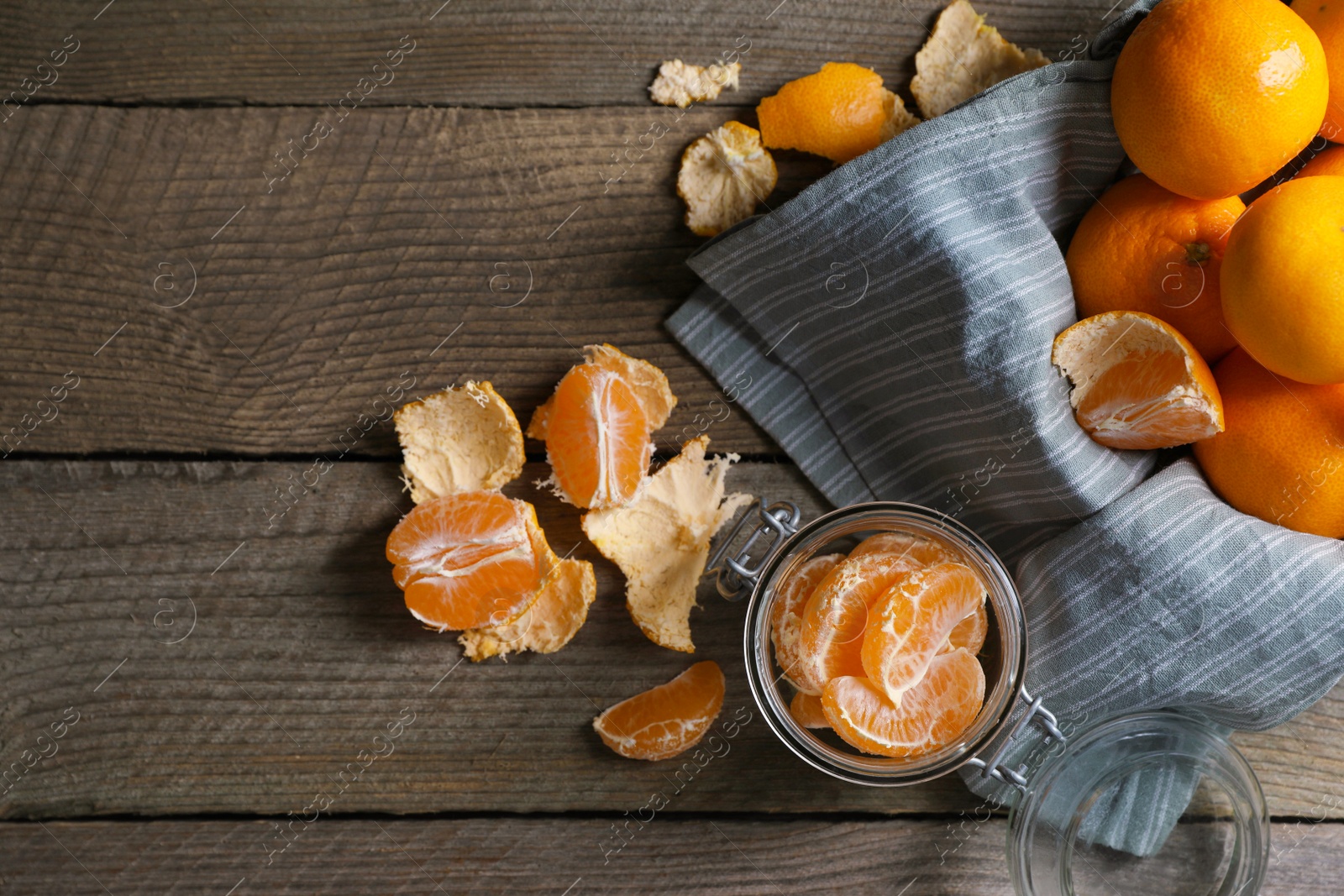 Photo of Many fresh ripe tangerines on wooden table, flat lay. Space for text