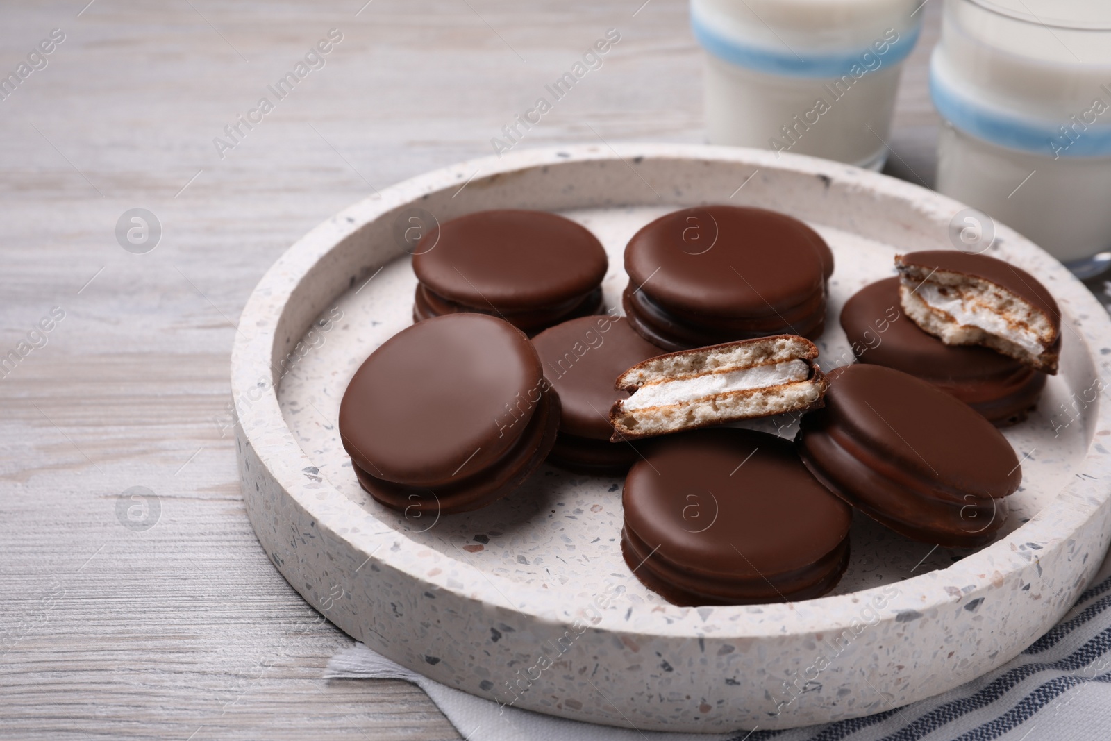 Photo of Tasty choco pies on white wooden table