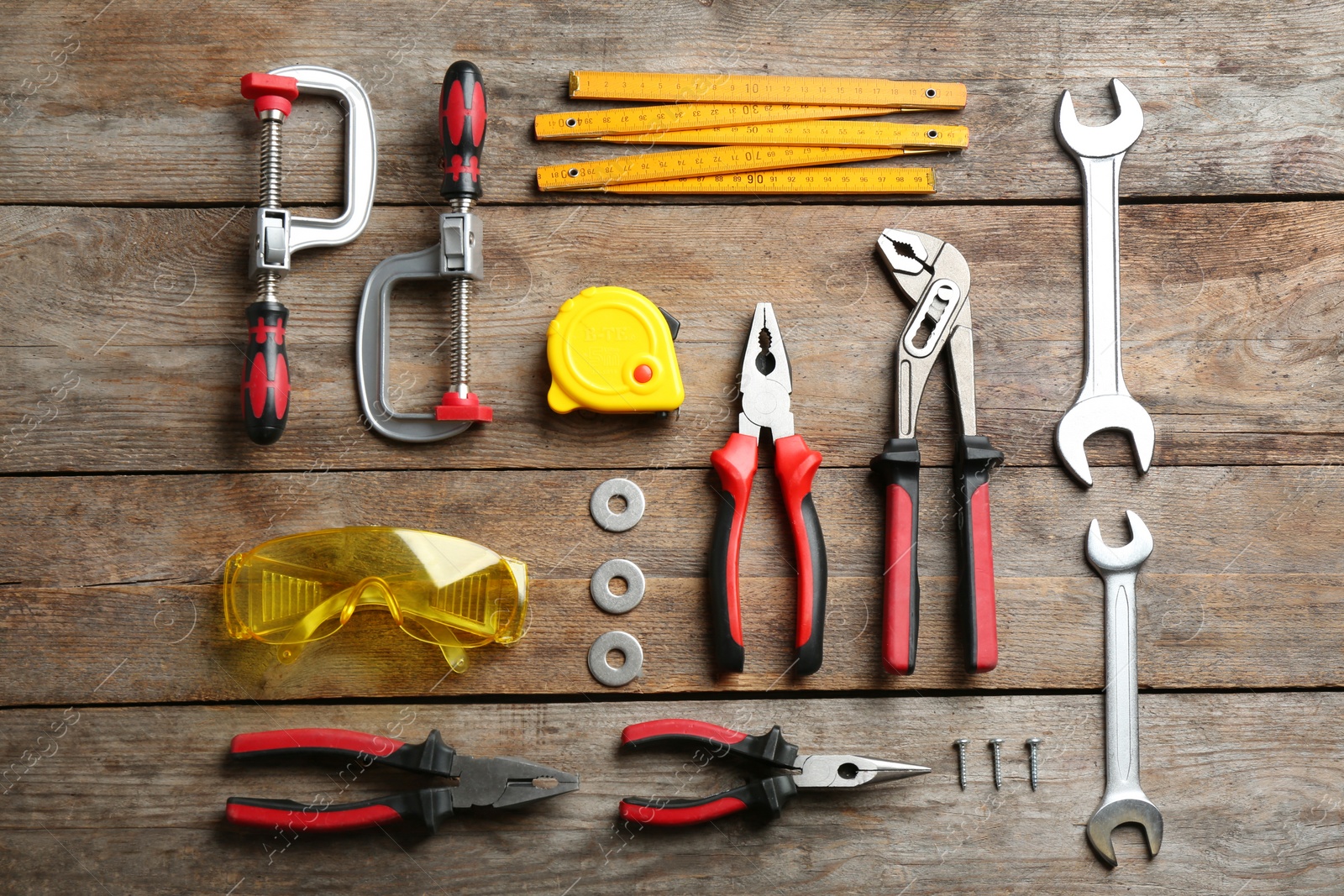 Photo of Flat lay composition with construction tools on wooden background