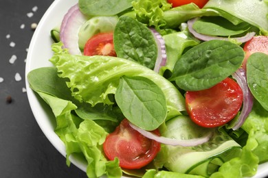 Delicious vegetable salad on grey table, closeup