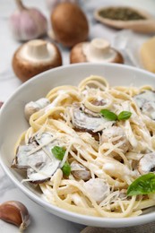 Photo of Delicious pasta with mushrooms on white table, closeup