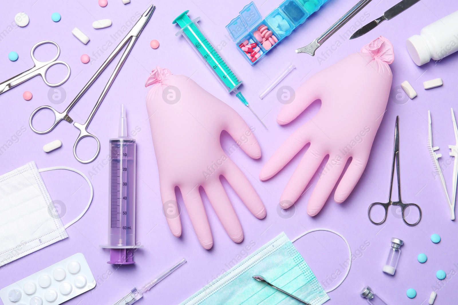 Photo of Flat lay composition with medical gloves on color background