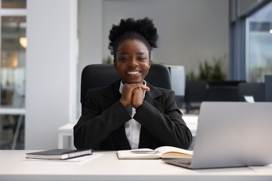 Happy woman working at table in office. Lawyer, businesswoman, accountant or manager