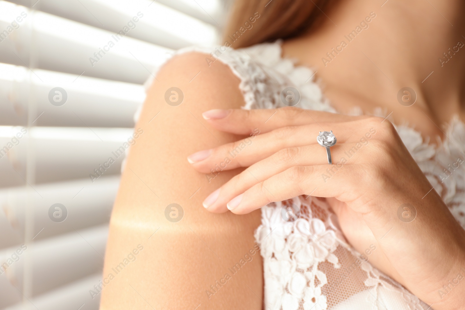 Photo of Young bride wearing beautiful engagement ring, closeup