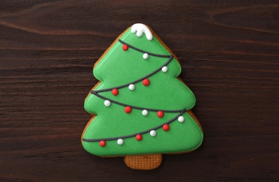 Christmas tree shaped cookie on wooden table, top view