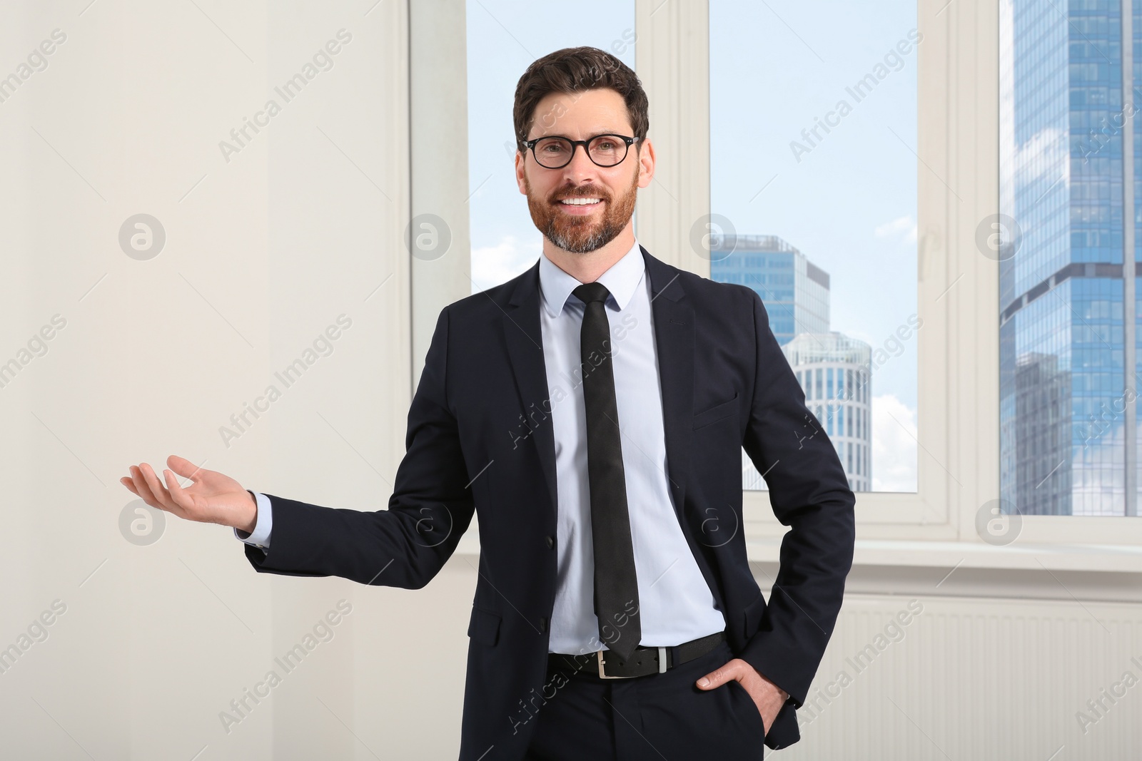 Photo of Handsome real estate agent in nice suit indoors