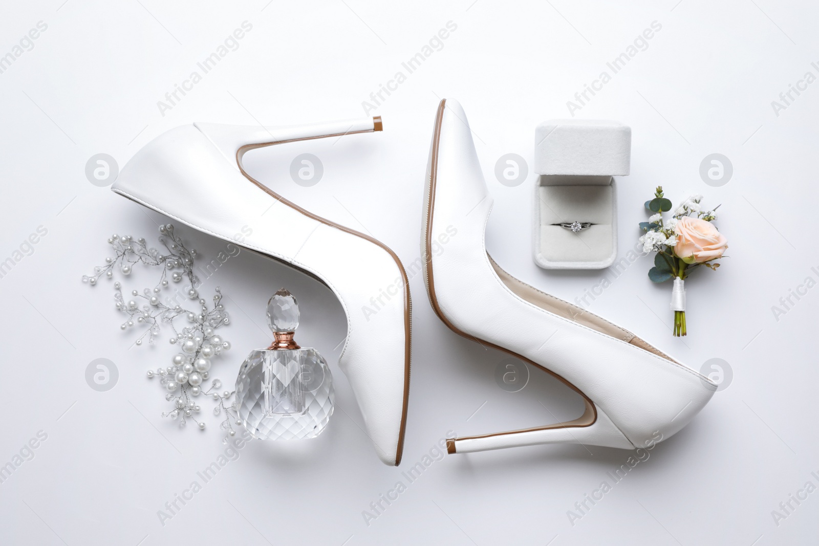 Photo of Composition with wedding high heel shoes on white background, top view