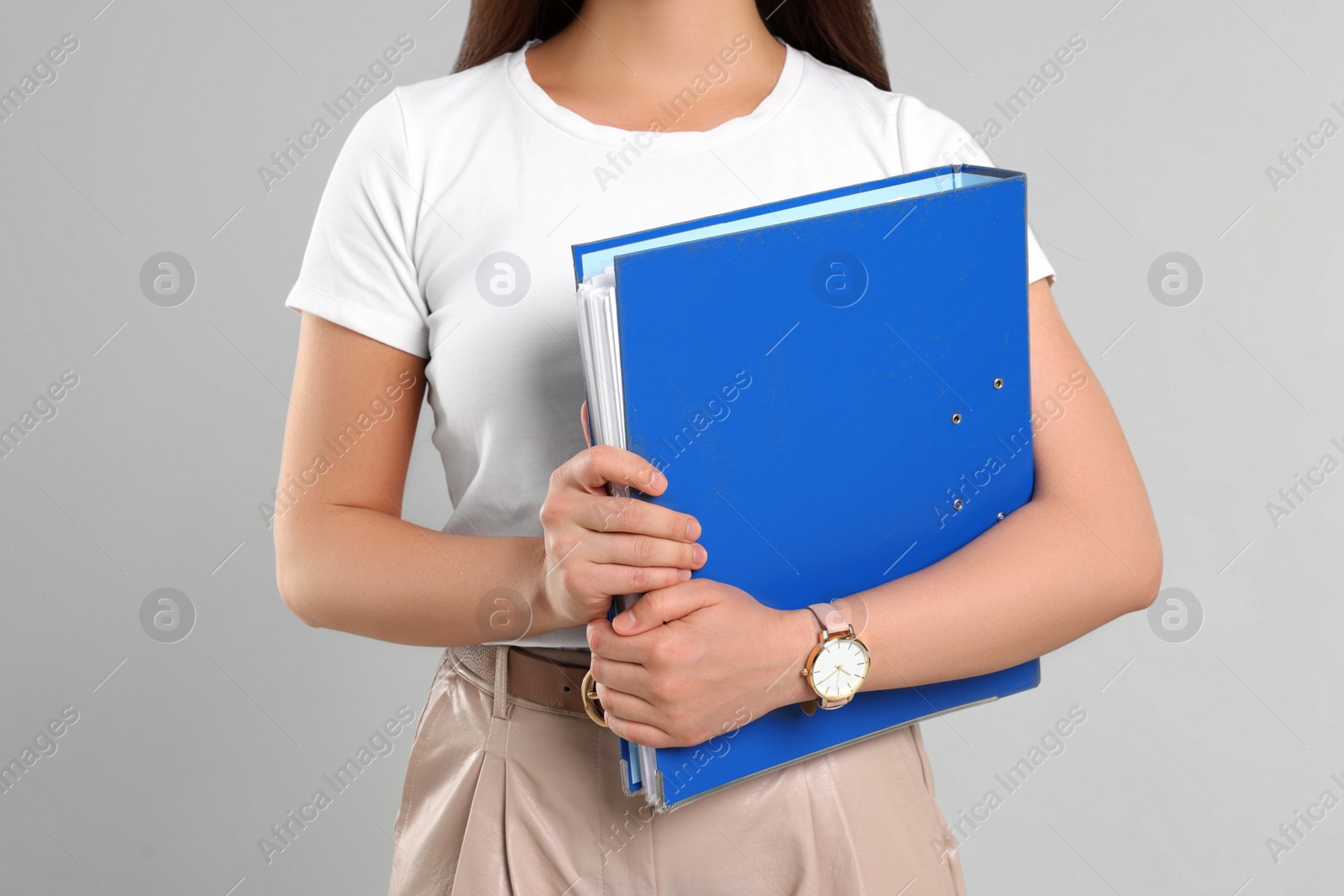 Photo of Woman with folder on light gray background, closeup