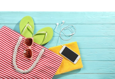 Photo of Flat lay composition with beach accessories on wooden background. Space for text