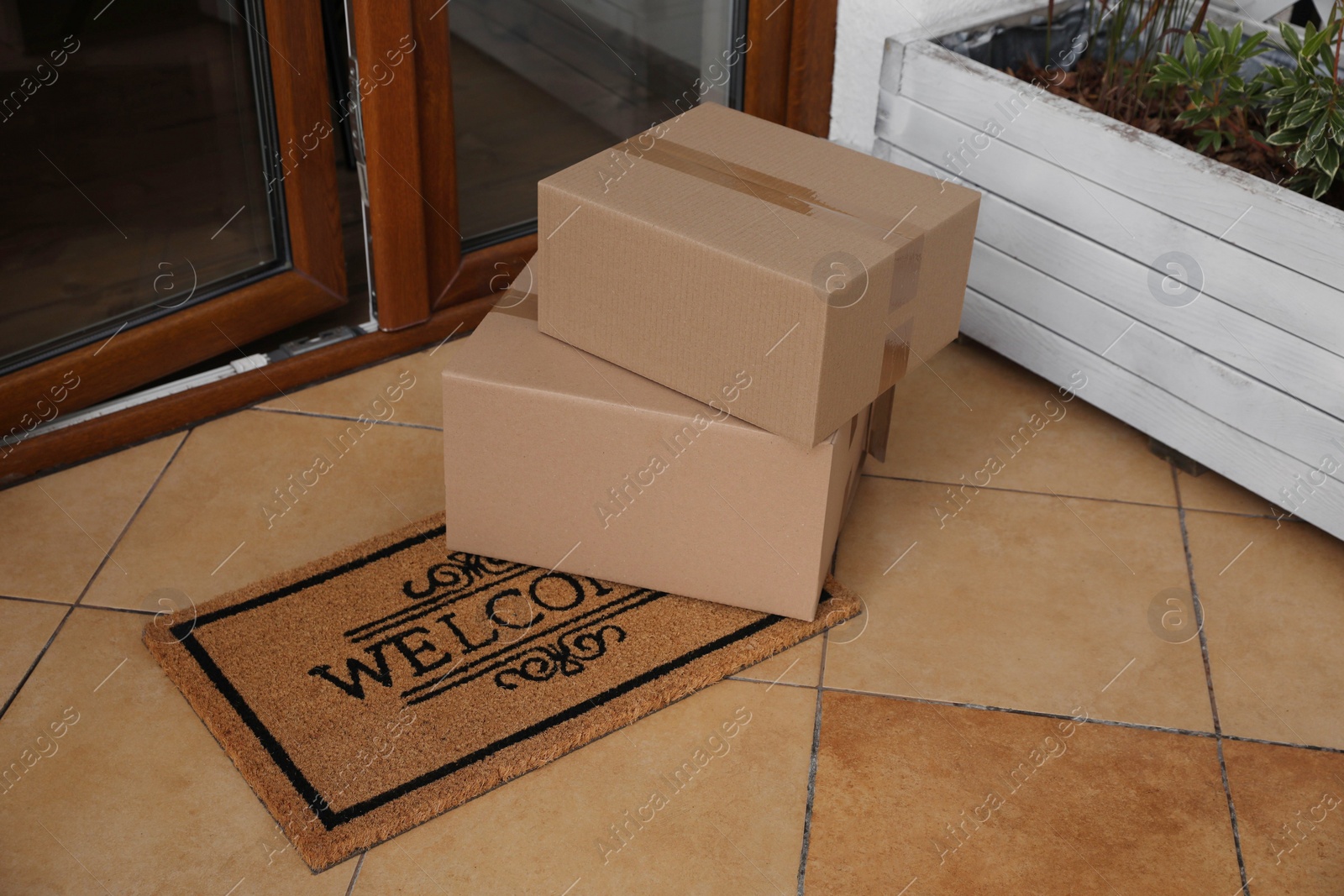 Photo of Parcels delivered on mat near front door