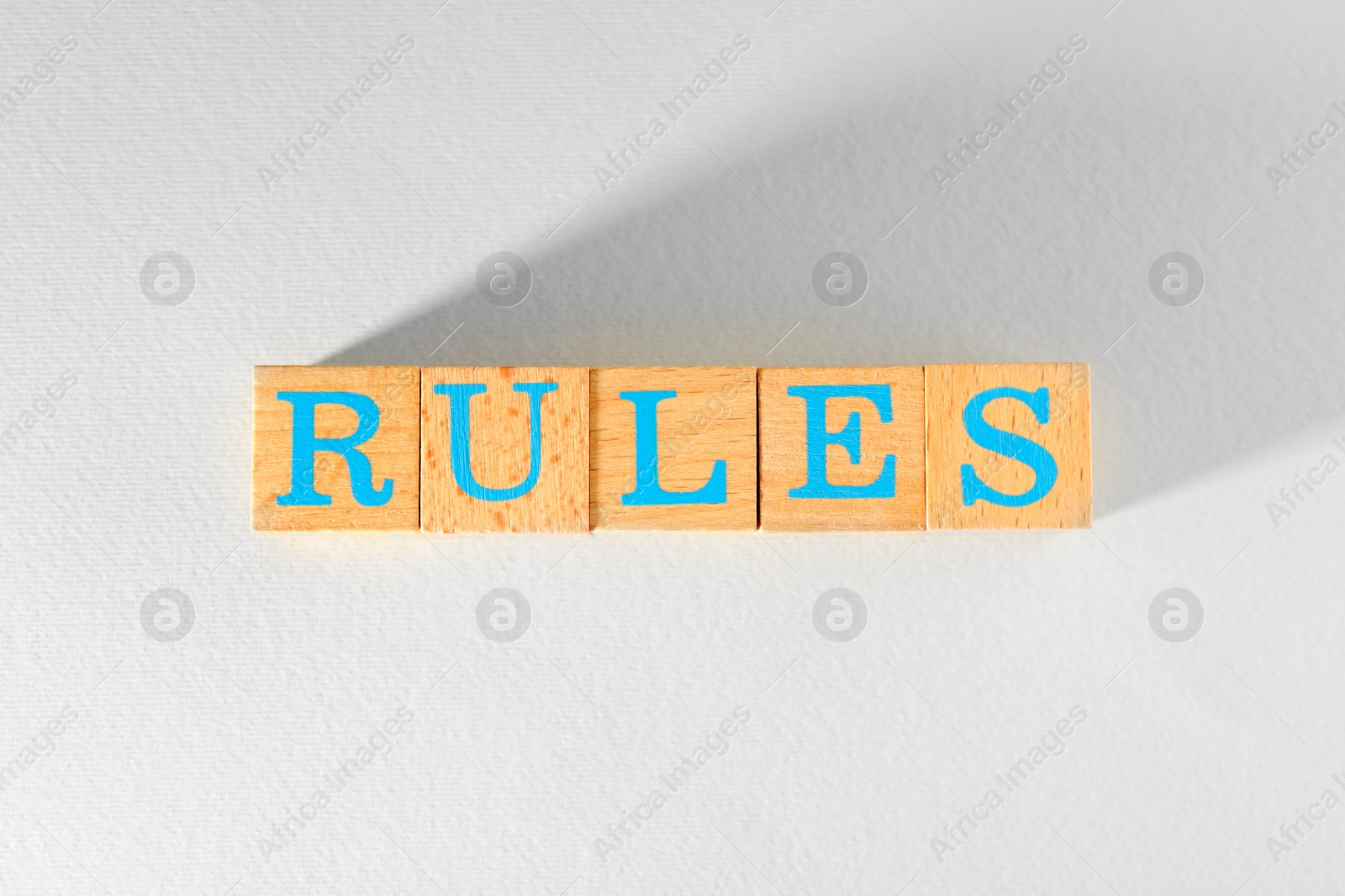 Photo of Word Rules made of wooden cubes with letters on white background, top view