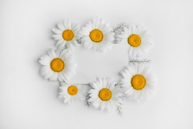 Photo of Beautiful floral composition with chamomile flowers and card on white background, top view