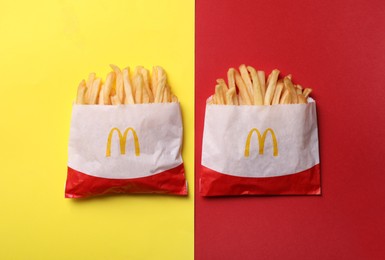 Photo of MYKOLAIV, UKRAINE - AUGUST 12, 2021: Two small portions of McDonald's French fries on color background, flat lay