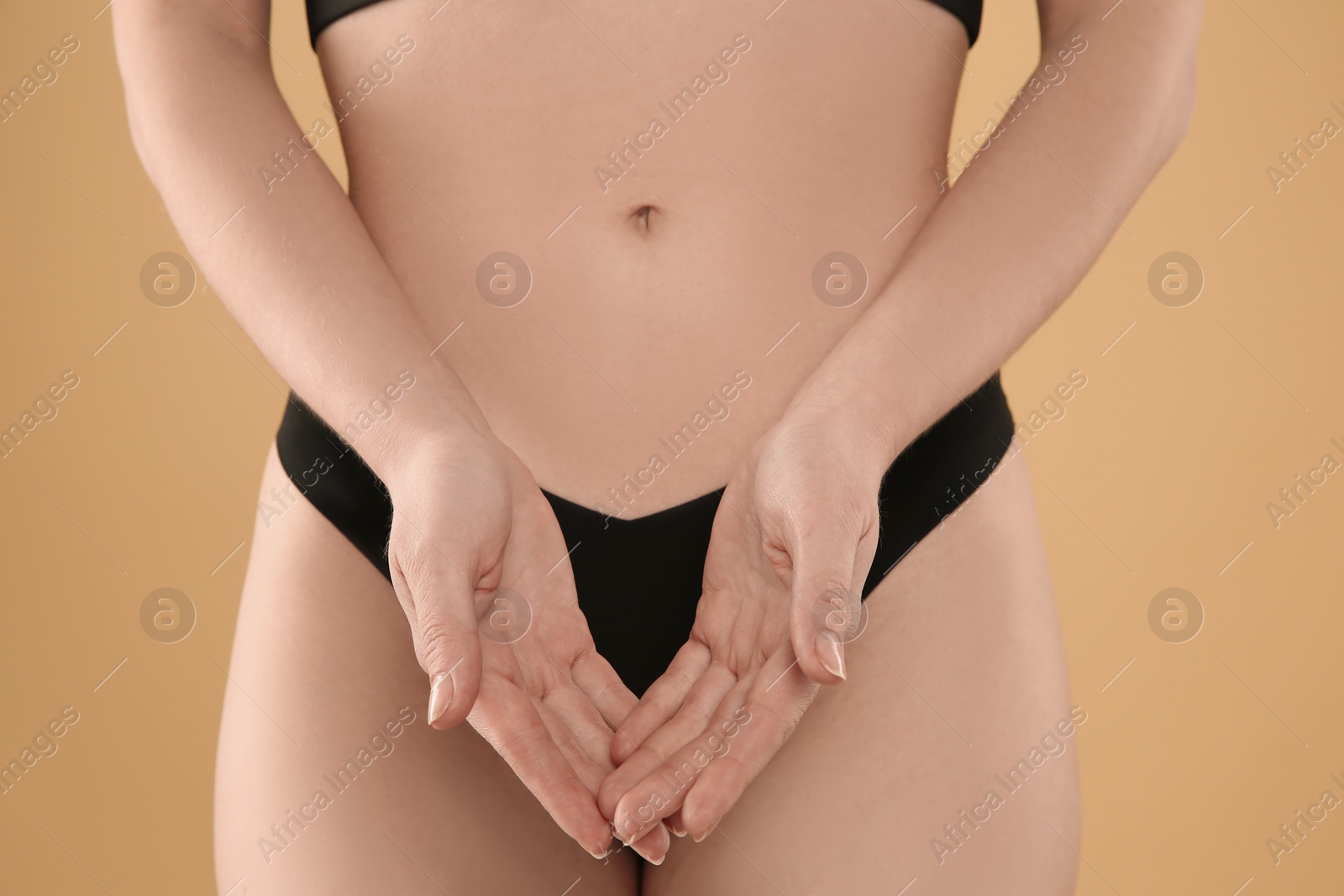 Photo of Gynecology. Woman in underwear on yellow background, closeup