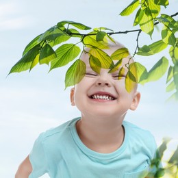 Double exposure of laughing boy and green tree against sky