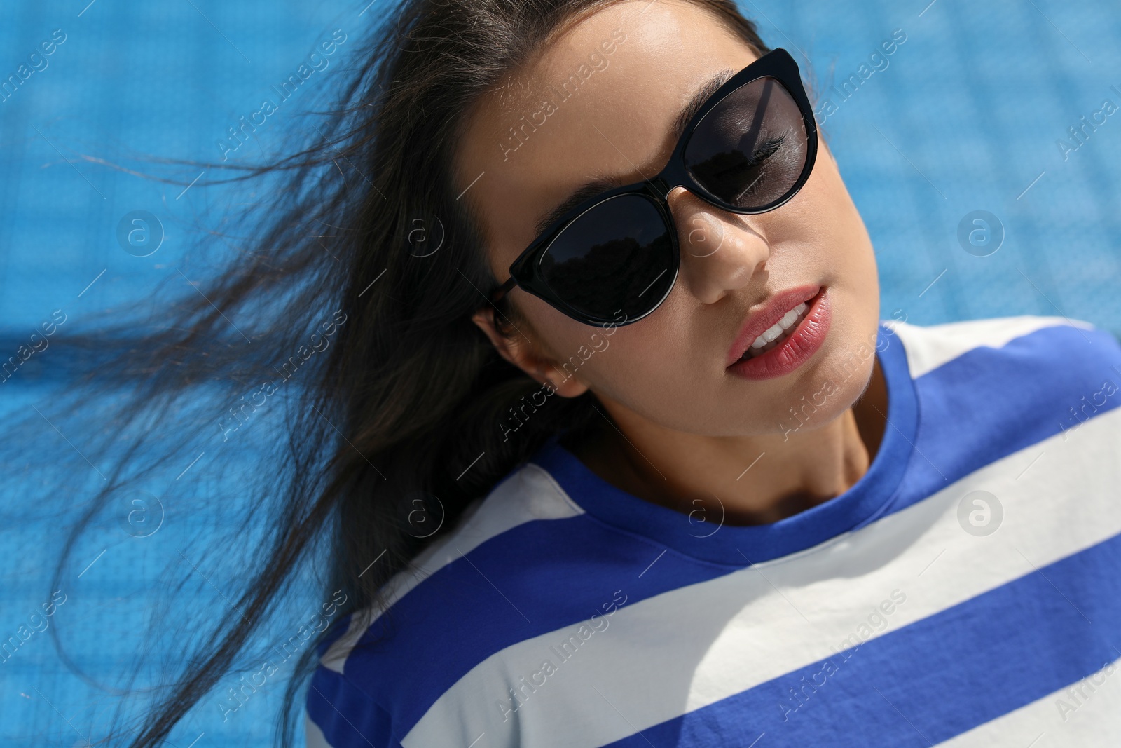 Photo of Beautiful woman in sunglasses outdoors on sunny day