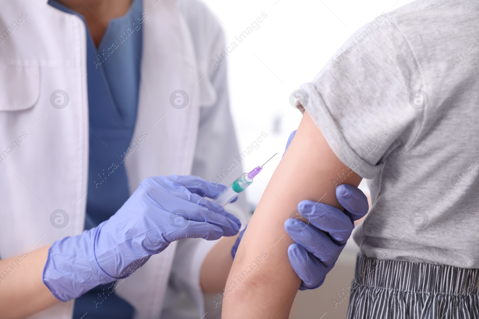 Photo of Little girl receiving chickenpox vaccination in clinic, closeup. Varicella virus prevention