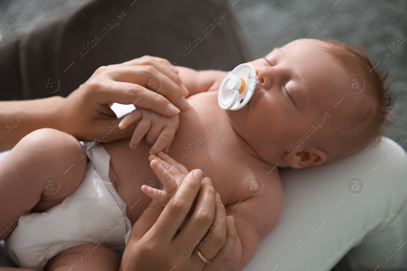 Photo of Mother with her newborn baby, closeup view