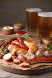 Photo of Set of different tasty snacks on wooden table, closeup view