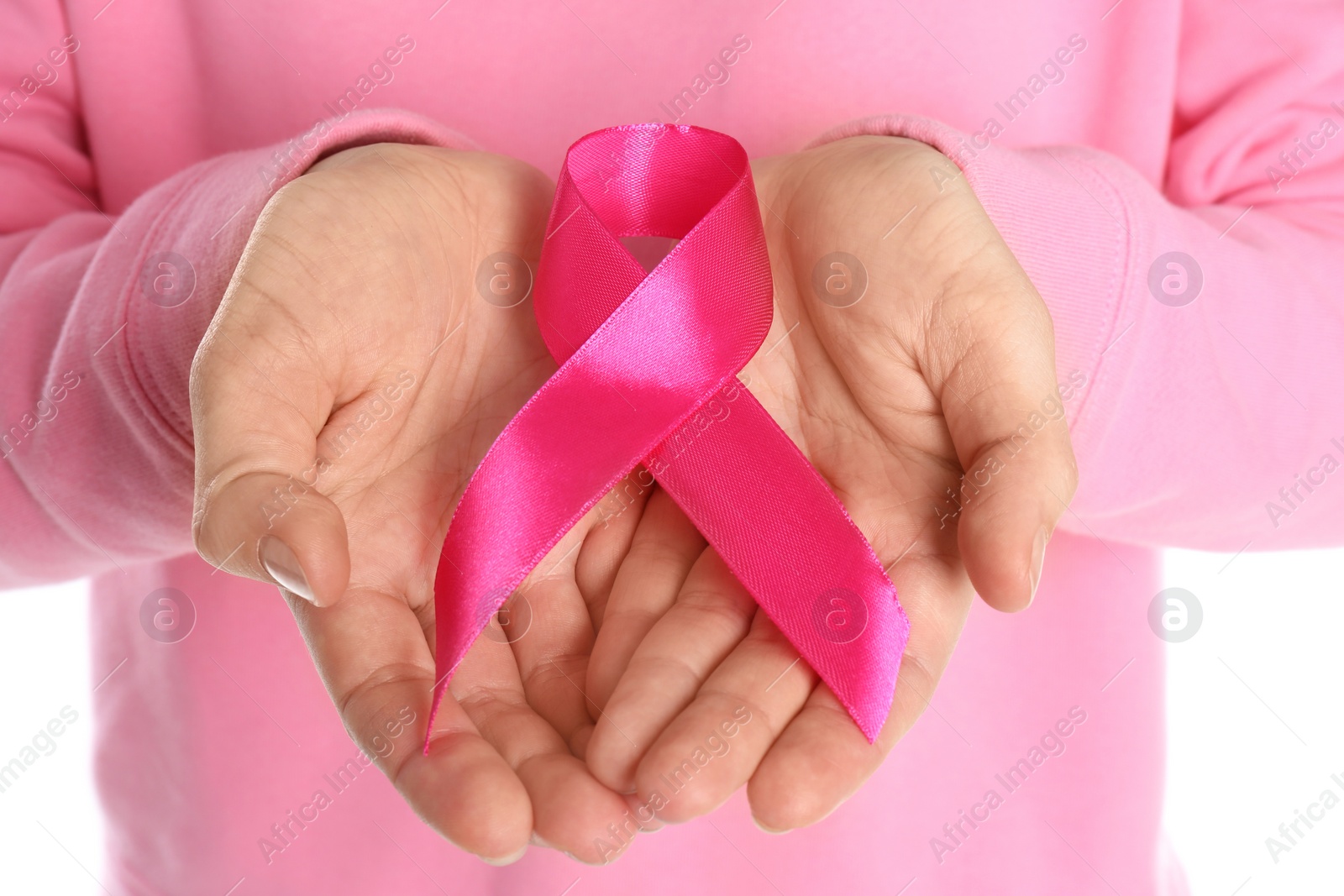 Photo of Woman holding pink ribbon on white background, closeup. Breast cancer awareness