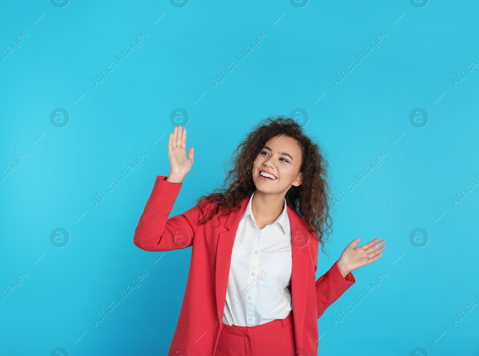 Photo of Portrait of emotional African-American businesswoman on color background