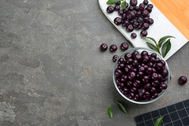 Flat lay composition with tasty acai berries on grey table. Space for text