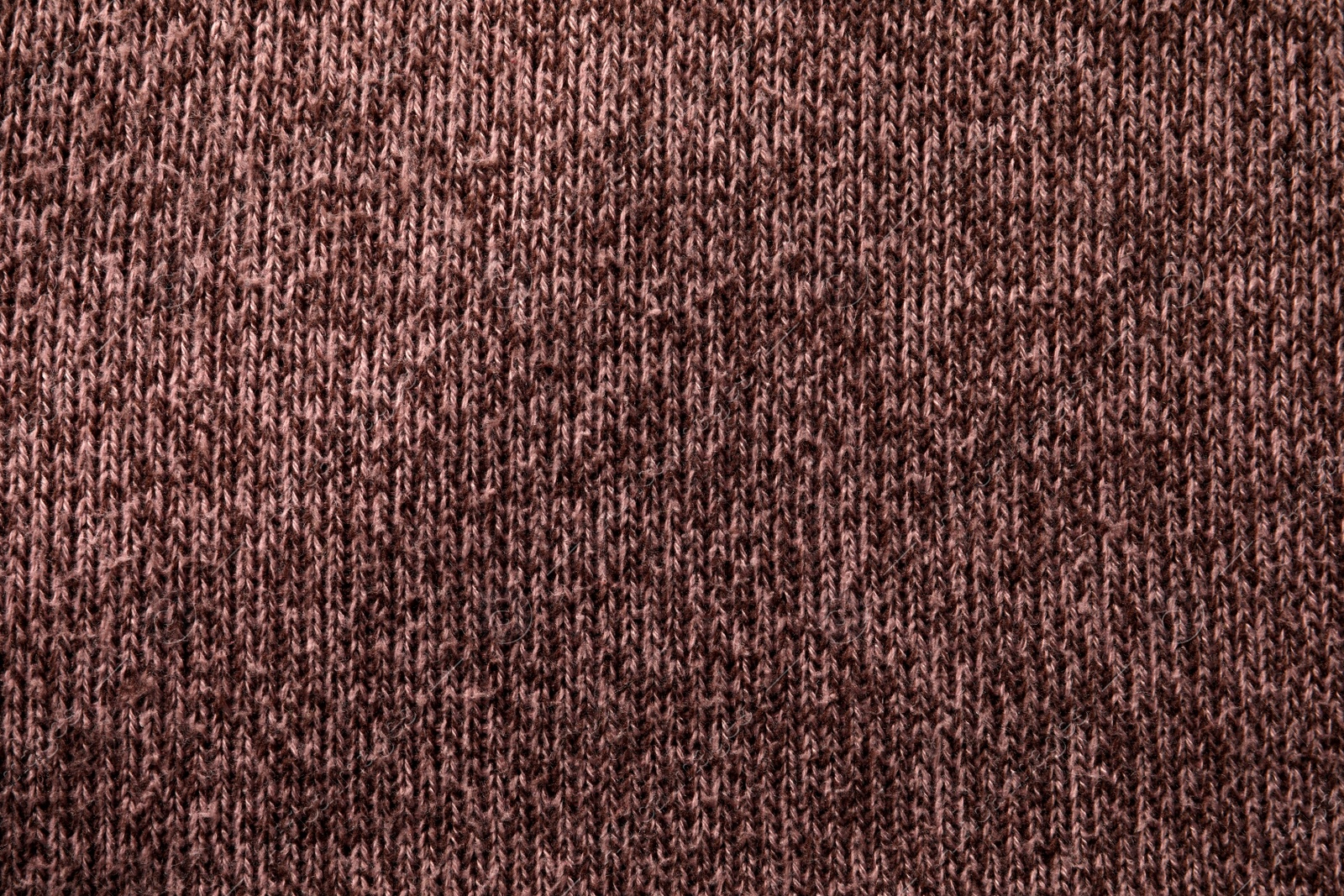 Photo of Knitted cloth with lint as background, top view. Before using of fabric shaver