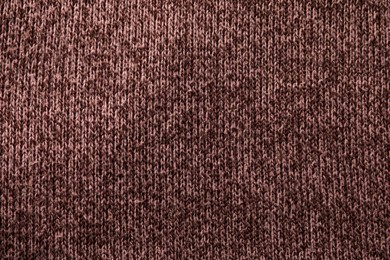 Photo of Knitted cloth with lint as background, top view. Before using of fabric shaver