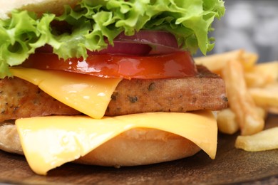 Photo of Delicious burger with tofu and fresh vegetables on wooden table, closeup