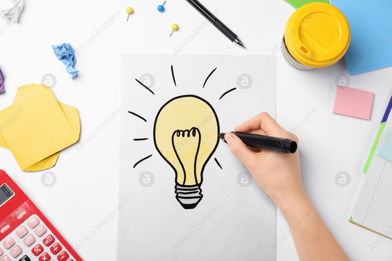 Photo of Woman drawing light bulb on white background. Business trainer concept