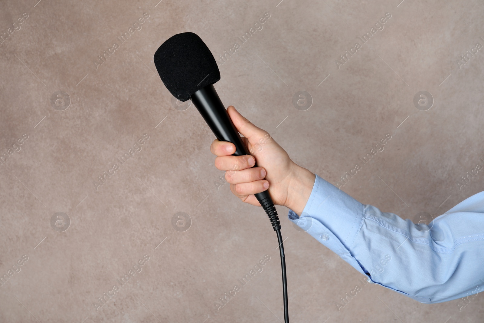 Photo of Woman holding microphone on color background, space for text