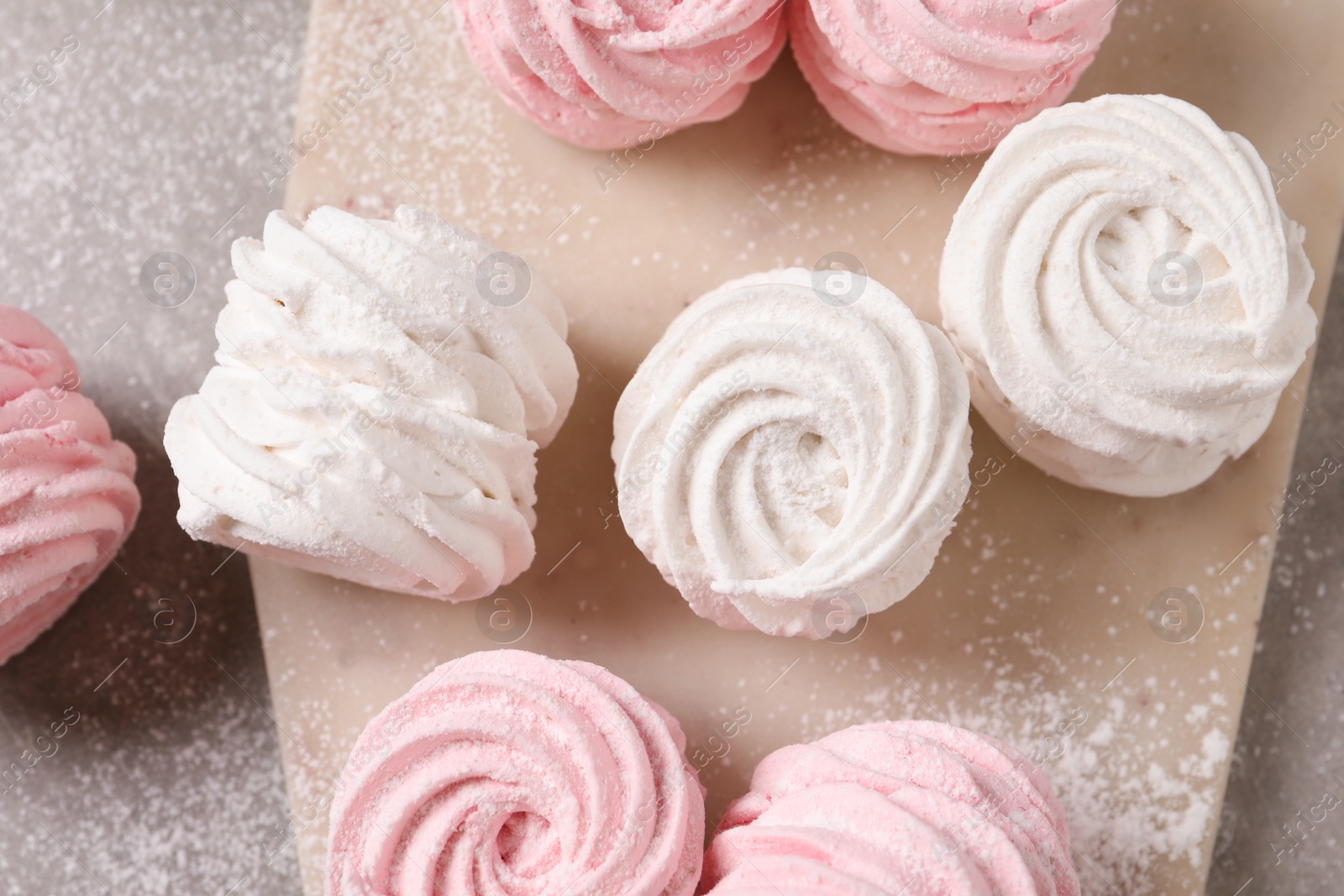 Photo of Delicious pink and white marshmallows on grey table, flat lay