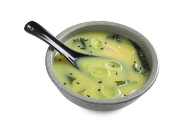 Bowl of delicious miso soup with tofu and spoon isolated on white