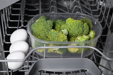 Cooking raw broccoli and eggs in modern dishwasher, closeup