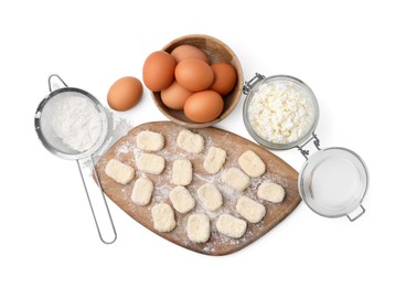 Photo of Making lazy dumplings. Wooden board with cut dough and ingredients isolated on white, top view