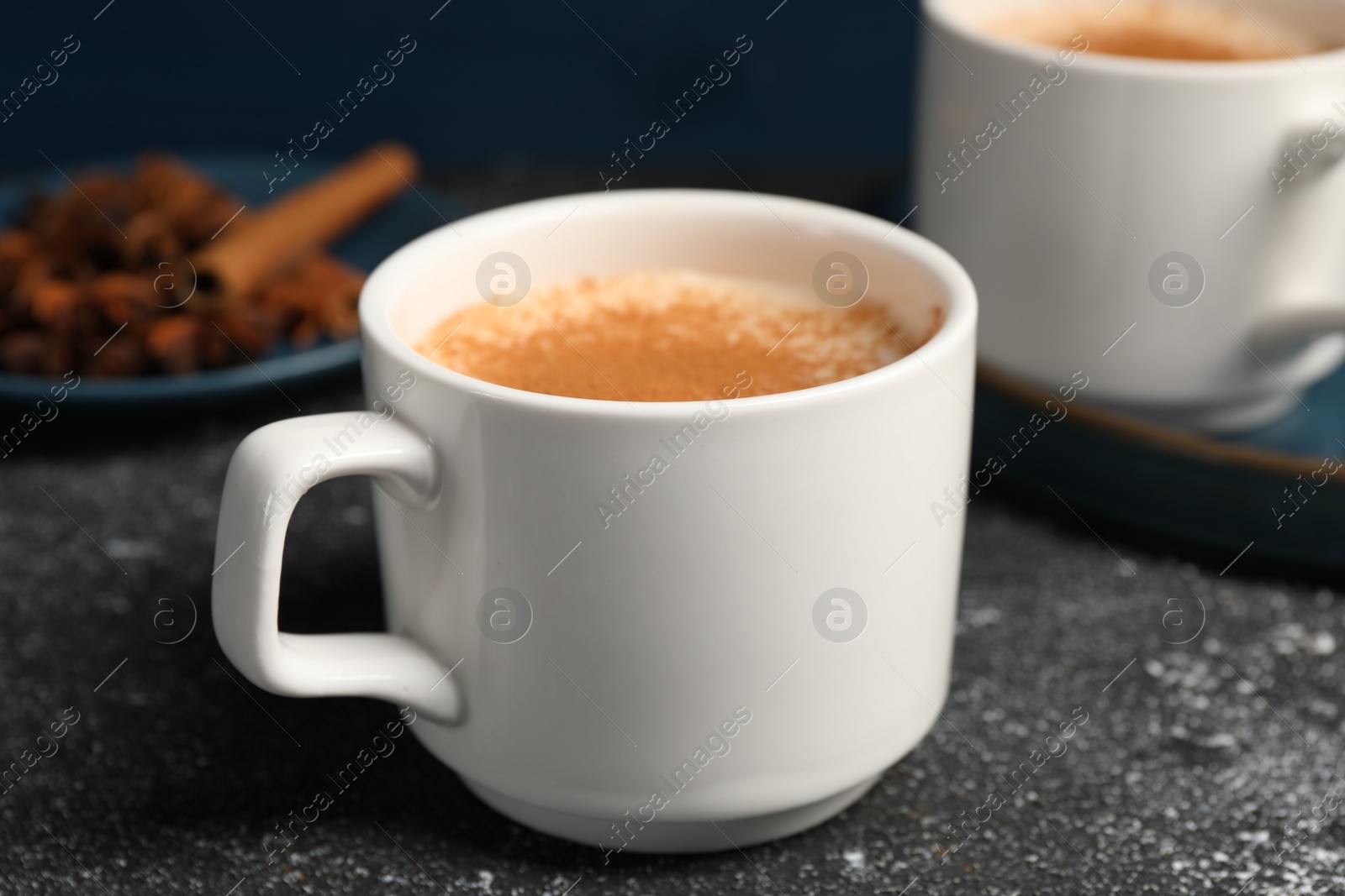 Photo of Delicious eggnog with anise and cinnamon on grey table