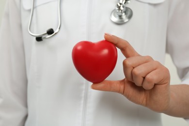 Photo of Doctor holding red heart, closeup. Cardiology concept