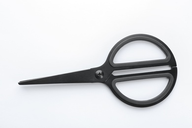 Photo of Pair of sharp scissors on white background