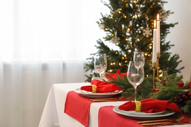 Photo of Beautiful table setting with Christmas decor in room, space for text