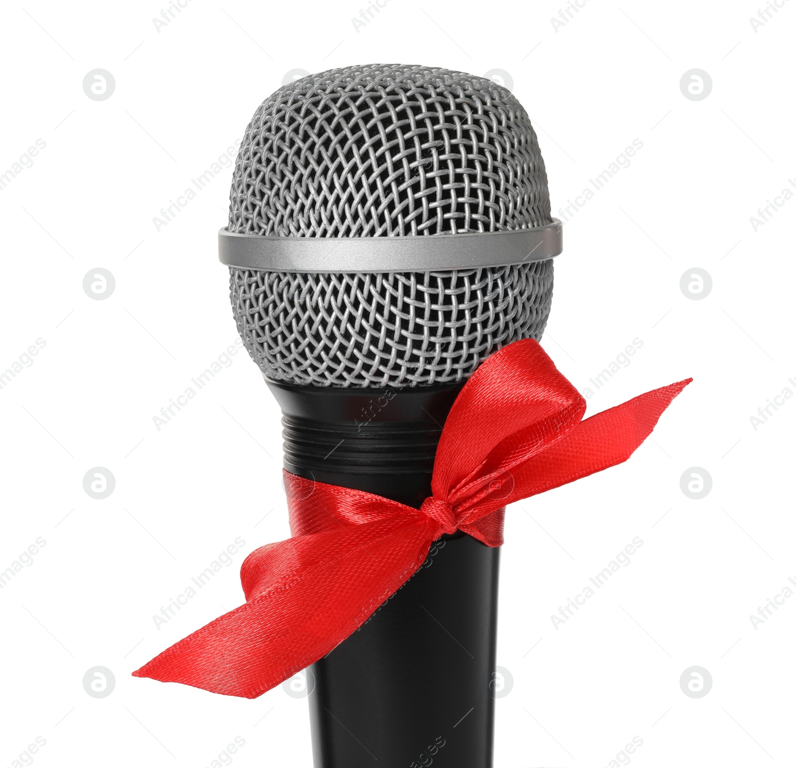 Photo of Microphone with red bow isolated on white, closeup. Christmas music