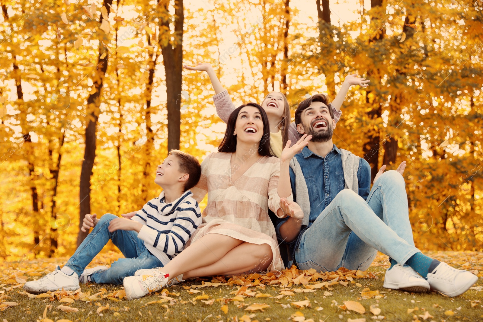 Photo of Happy family with children spending time in park. Autumn walk