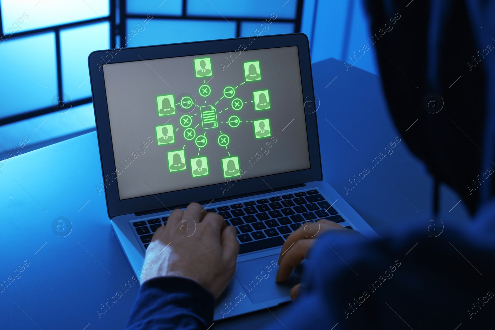 Image of Hacker cracking access to documents using laptop