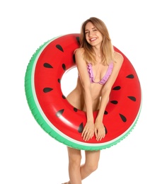 Beautiful young woman in stylish bikini with watermelon inflatable ring on white background